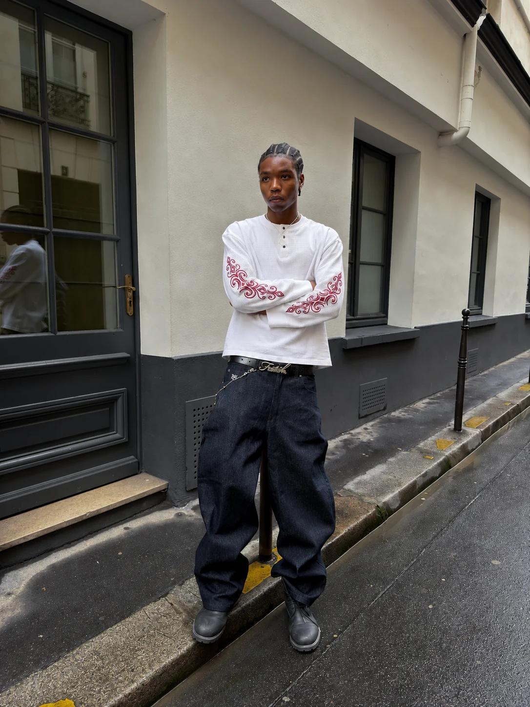 White waffle henley with red embroidered sleeves and raw denim, worn in the street